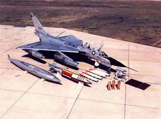 an air force jet sitting on top of an airport tarmac next to other planes