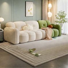 a white couch sitting on top of a rug in a living room