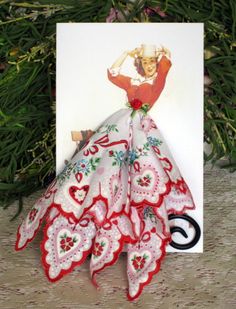 a christmas card with a red and white dress on it