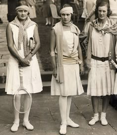 three women in tennis uniforms standing next to each other