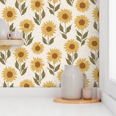 a kitchen counter with sunflowers painted on the wall behind it and a vase