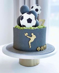 a mickey mouse cake with soccer balls on top