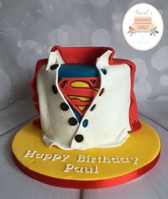 a birthday cake with a superman symbol on it