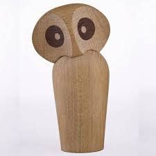 an owl statue made out of wood on a white background