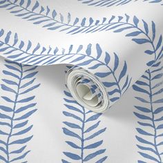 a blue and white wallpaper with leaves on it