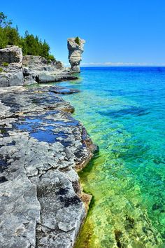 the water is crystal blue and green with rocks on both sides in front of it