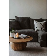 a living room with a couch, coffee table and two candles on top of it