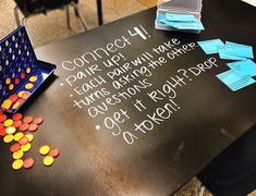 a black table topped with lots of colorful candies next to a sign that says connect