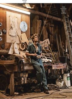 a man sitting on top of a wooden bench