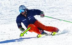 a man riding skis down the side of a snow covered slope with an arrow pointing to his left