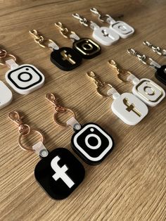 several different types of cell phones and key chains on a wooden table with one being an instagram symbol