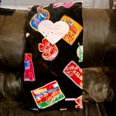 a couch covered in different types of candies and other things on the back of it