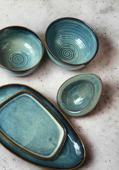 three blue bowls sitting next to each other on a table