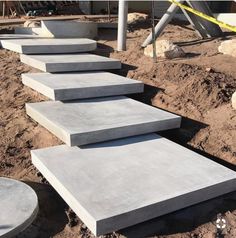 concrete steps are lined up in the dirt