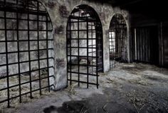 an old jail cell with bars and windows