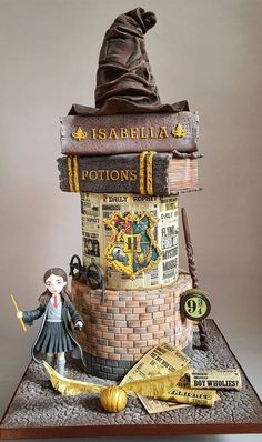 a cake made to look like a wizard's hat on top of a stack of books