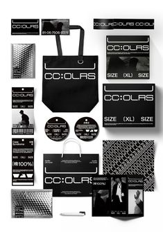 an assortment of black and white business cards, cd's, and envelopes