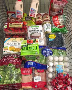 a shopping cart filled with groceries and condiments