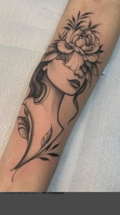 a woman's face with flowers on her arm