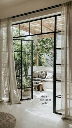 an open door leading into a living room with sheer curtains