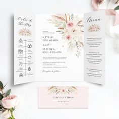 an open wedding program with flowers and greenery on the front, in pink tones