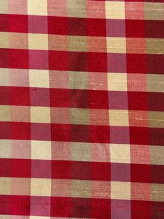 a red and beige checkered fabric is shown