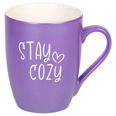 a purple coffee mug with the words stay cozy written on it