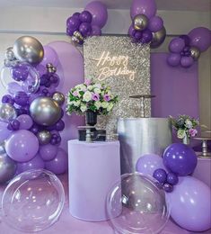 purple and silver balloons are on the table