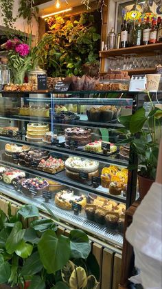 a display case filled with lots of different types of cakes and pastries in a store