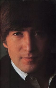 a close up of a person wearing a suit and tie with his hair in the wind