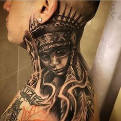 a man with tattoos on his neck and head