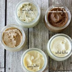 four jars filled with different types of body butter on top of a wooden table next to each other