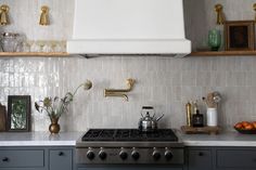 a stove top oven sitting inside of a kitchen next to counter tops and shelves above it