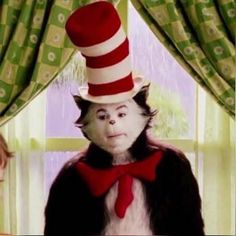 the cat in the hat is wearing a red bow tie