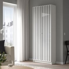 a living room with a white radiator next to a window