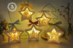 five star shaped lights with bows on them