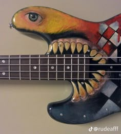 a painted guitar with teeth on it