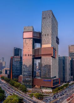 an aerial view of some very tall buildings in the middle of a busy city street