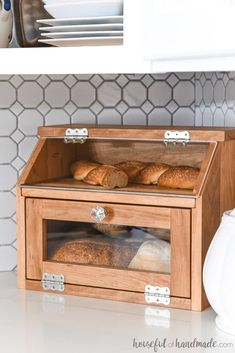 a wooden box with bread in it and the words build a diy bread box