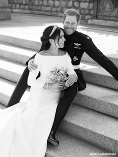 a man and woman are sitting on the steps posing for a wedding photo in black and white