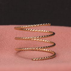 This beautiful Twisted Rope Double Spiral Ring can be made from Sterling Silver, 14K Gold Fill, or 14K Rose Gold Fill. The ring is shined to a mirror finish and is a beautiful piece of jewelry that stands out boldly, while still remaining minimalistic. The ring is adjustable and holds it's shape well, with the ability to be squeezed together for closer coils.PRODUCT DETAILS & MEASUREMENTS- 100% Handmade in the USA.- Sold individually.- Choose your size via the drop-down menu.- Ring is made e Coil Ring, Tarnish Remover, Spiral Ring, Gold Wrap, Hammered Rings, Golden Jewelry, Bypass Ring, Monogram Jewelry, Braided Rope