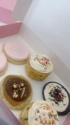 a box filled with lots of different flavored doughnuts on top of each other