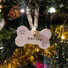 a dog bone ornament hanging from a christmas tree