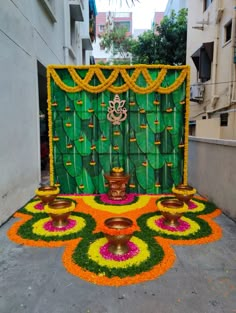 an outdoor decoration with flowers and candles on the ground