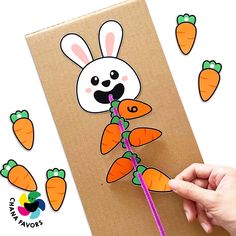 a hand holding a straw with carrots on it and an image of a bunny