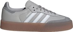 Designed with a modern twist on an iconic silhouette, these adidas Women's Sambae Shoes feature a smooth nubuck and leather upper complemented by premium embroidered 3-Stripes. Subtle details such as a stitch-and-turn toe cap and a translucent gum rubber outsole add both style and functionality. Perfect for casual wear, these shoes offer a comfortable fit with a lace-up closure, making them an ideal addition to any wardrobe. Design: These Sambae shoes add a modern twist to the iconic design of t Samba Shoes, Adidas Country, Adidas Sneakers Women, Football Shoes, Hot Sneakers, Womens Athletic Shoes, Iconic Design, Cloud White, Wardrobe Design