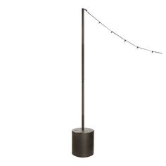 a floor lamp that is on top of a pole and has some lights attached to it