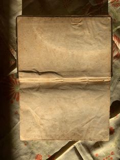 an old piece of brown paper sitting on top of a bed