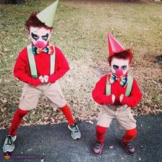 two young boys dressed in clown costumes standing next to each other