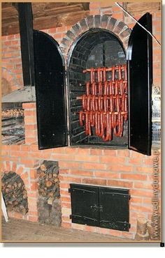 a brick oven with hot dogs cooking in it